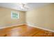 Bedroom with a ceiling fan, natural lighting from a window, and beautiful wood flooring at 1753 28Th Ne St, Hickory, NC 28601