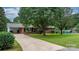 Brick ranch home featuring a covered carport and mature landscaping, set back from the street at 1753 28Th Ne St, Hickory, NC 28601