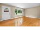 Bright front room featuring gleaming hardwood floors and a large window for ample natural light at 1753 28Th Ne St, Hickory, NC 28601