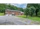 Expansive backyard with a brick home, a large parking area, and a chain-link fence at 1753 28Th Ne St, Hickory, NC 28601