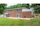 Rear exterior view of a brick home with a patio, a fenced yard, and access to a garage at 1753 28Th Ne St, Hickory, NC 28601