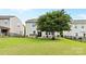 Spacious backyard featuring a well-maintained lawn, mature tree, patio, and fenced perimeter offering privacy and room for recreation at 2042 Newport Dr, Fort Mill, SC 29707