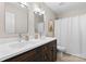 Elegant bathroom featuring a double sink vanity, two mirrors, and shower with curtain at 2042 Newport Dr, Fort Mill, SC 29707
