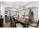 Open-concept dining room featuring an elegant chandelier, wainscoting, neutral paint, and a large table with seating at 2042 Newport Dr, Fort Mill, SC 29707
