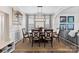 Elegant dining room with modern chandelier, wainscoting, neutral paint and a large table perfect for entertaining at 2042 Newport Dr, Fort Mill, SC 29707
