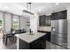 Modern eat-in kitchen with stainless appliances, granite island, stylish pendant lights, and outdoor views at 2042 Newport Dr, Fort Mill, SC 29707