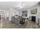Bright living room features a fireplace, modern lighting, and seamlessly connects to other areas of the home at 2042 Newport Dr, Fort Mill, SC 29707