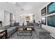 Spacious living room featuring a comfortable sectional sofa, stylish rug, and view into the dining area at 2042 Newport Dr, Fort Mill, SC 29707