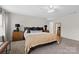 Bright main bedroom featuring a bed, nightstands, mirror, and carpet flooring at 2042 Newport Dr, Fort Mill, SC 29707