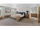 Spacious main bedroom with a bed, neutral decor, bench, and large windows at 2042 Newport Dr, Fort Mill, SC 29707