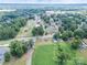 Aerial view of neighborhood homes nestled among lush green trees with a blue sky overhead at 206 13Th St, Belmont, NC 28012