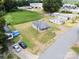 Aerial view showcasing homes, a large grassy lot, commercial building, and nearby parking at 206 13Th St, Belmont, NC 28012