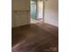 Bedroom featuring hardwood floors, paneled walls, and a doorway at 206 13Th St, Belmont, NC 28012