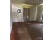Unfurnished bedroom with hardwood floors, white-painted wood walls, and neutral curtains under a window at 206 13Th St, Belmont, NC 28012