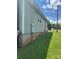 A side view of the house with light gray vinyl siding, a green lawn, and a clear blue sky at 206 13Th St, Belmont, NC 28012
