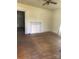 Empty living room with hardwood floors, a decorative fireplace, and a glimpse into an adjoining room at 206 13Th St, Belmont, NC 28012