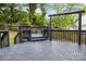 Backyard deck features gray tiles and a dark gray railing at 2112 Flint Glenn Ln, Charlotte, NC 28262