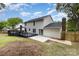White house with a patio, wooden deck, and landscaped backyard at 2112 Flint Glenn Ln, Charlotte, NC 28262