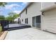 Spacious backyard with a black deck, patio area, and sliding glass door access at 2112 Flint Glenn Ln, Charlotte, NC 28262