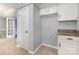 Basement area featuring white cabinets, granite counters, and access to another room via a white door at 2112 Flint Glenn Ln, Charlotte, NC 28262