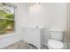 Bathroom with vanity, toilet, and natural light from the window at 2112 Flint Glenn Ln, Charlotte, NC 28262