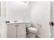 Powder room featuring a toilet and vanity with white cabinets at 2112 Flint Glenn Ln, Charlotte, NC 28262