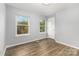 A bedroom features sleek flooring, multiple windows, and a door to the side at 2112 Flint Glenn Ln, Charlotte, NC 28262