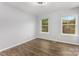Bedroom showing neutral walls and flooring with windows overlooking a green yard at 2112 Flint Glenn Ln, Charlotte, NC 28262