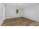 A well-lit bedroom features sleek flooring and a window with trees outside at 2112 Flint Glenn Ln, Charlotte, NC 28262