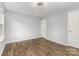 A well-lit bedroom features sleek flooring and two access doors at 2112 Flint Glenn Ln, Charlotte, NC 28262