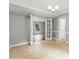 Dining room with tan tiled floors and white chair rail open to a room with light grey walls and wood-look flooring at 2112 Flint Glenn Ln, Charlotte, NC 28262