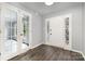 Bright foyer with hardwood floors, stained-glass-accented front door, and French doors leading to another room at 2112 Flint Glenn Ln, Charlotte, NC 28262