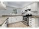 Bright kitchen featuring white cabinets, granite countertops, and stainless-steel appliances at 2112 Flint Glenn Ln, Charlotte, NC 28262