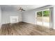 Living room with wood-look floors, fireplace, and sliding glass doors to the backyard at 2112 Flint Glenn Ln, Charlotte, NC 28262