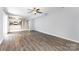 Open-concept living room with gray walls and laminate flooring, flowing into the kitchen at 2112 Flint Glenn Ln, Charlotte, NC 28262