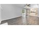 Open-concept living room with gray walls, wood floors, and sliding door access to a deck and an open view to the kitchen at 2112 Flint Glenn Ln, Charlotte, NC 28262