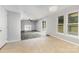 Open living space with fireplace and sliding glass doors to deck, connecting laminate and tiled flooring at 2112 Flint Glenn Ln, Charlotte, NC 28262