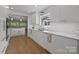 Bright kitchen with white cabinetry, marble countertops, stainless steel appliances, and hardwood floors at 2121 Valencia Ter, Charlotte, NC 28226