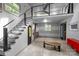 Open-concept living space featuring a staircase, kitchenette, and concrete flooring at 2121 Valencia Ter, Charlotte, NC 28226