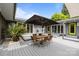 Inviting backyard with outdoor dining area, wooden table, and large umbrella at 2121 Valencia Ter, Charlotte, NC 28226