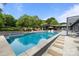 Beautiful backyard pool area with lounge chairs, lush landscaping and outdoor bar at 2121 Valencia Ter, Charlotte, NC 28226