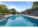 Backyard pool showcasing seating, lush landscaping and modern home exterior at 2121 Valencia Ter, Charlotte, NC 28226
