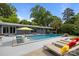Relaxing pool area featuring lounge chairs, umbrellas and stylish gray exterior at 2121 Valencia Ter, Charlotte, NC 28226