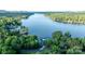 Aerial view of the lake with homes nestled among the trees along the shoreline at 24264 Strand Dr, Albemarle, NC 28001
