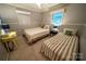 Cozy bedroom features two twin beds, two windows, and neutral decor at 24264 Strand Dr, Albemarle, NC 28001