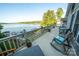 Spacious outdoor deck overlooking the lake with plenty of seating, plants and lake views at 24264 Strand Dr, Albemarle, NC 28001