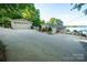 Exterior of home showcasing a driveway, garage, and partial lake view at 24264 Strand Dr, Albemarle, NC 28001