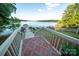 Scenic view of a lake house with steps leading down to the dock and serene water view at 24264 Strand Dr, Albemarle, NC 28001