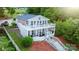 Aerial view of a charming lake house with multiple decks, steps to the lake, and landscaped yard at 24264 Strand Dr, Albemarle, NC 28001