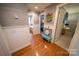 Hallway features hardwood floors with white trim, doors, and decorative fish art at 24264 Strand Dr, Albemarle, NC 28001
